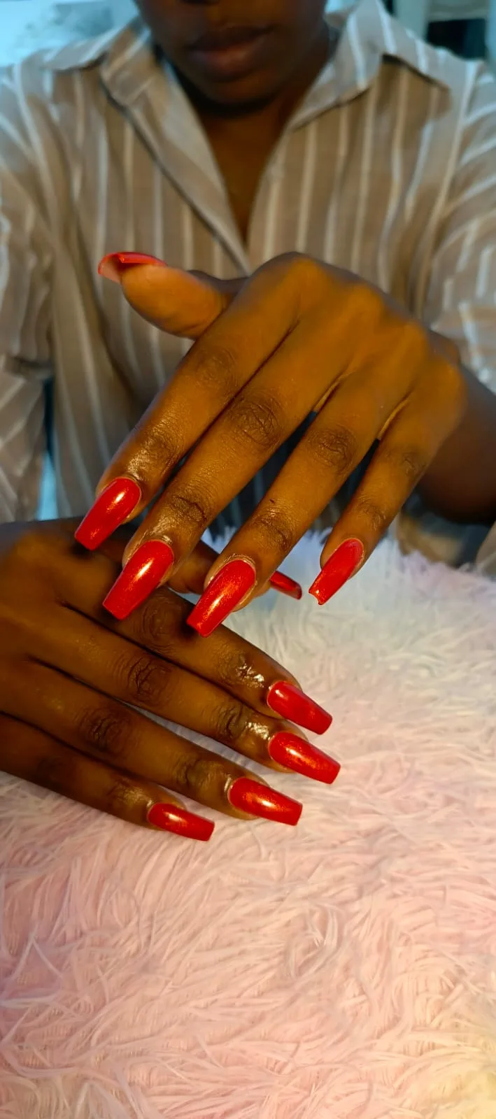 Long red coffin nails with a shimmering finish, supplied by NBD