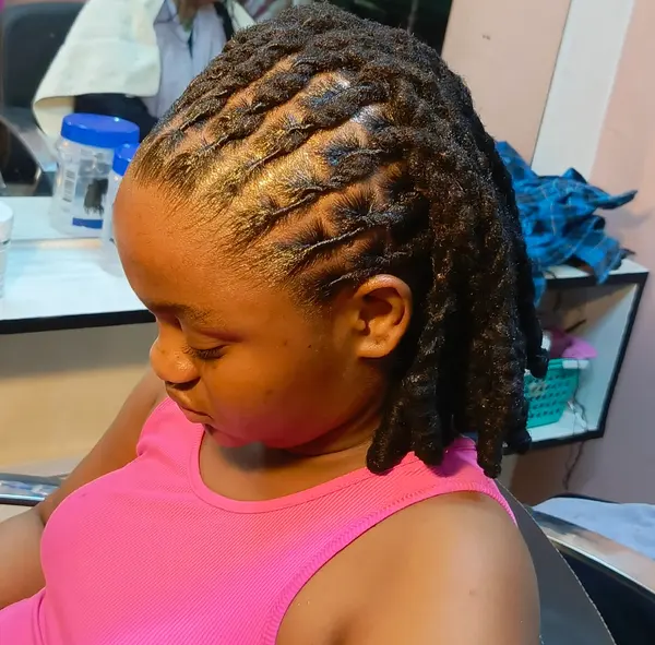 Short locs swept back in neatly sectioned rows, supplied by NBD