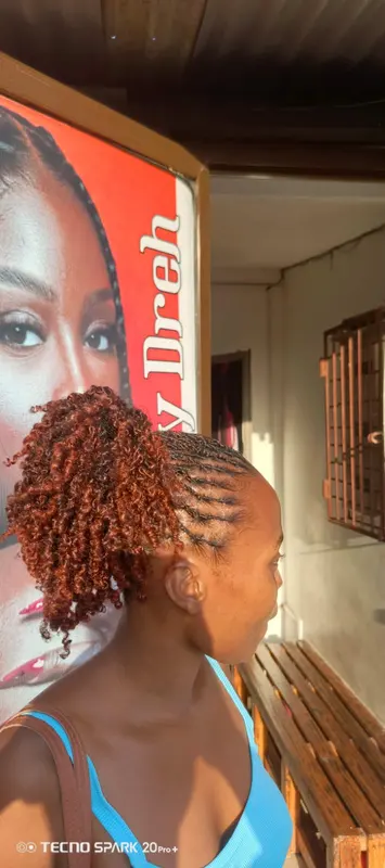 Cornrow styling finished with a copper curly ponytail, supplied by NBD