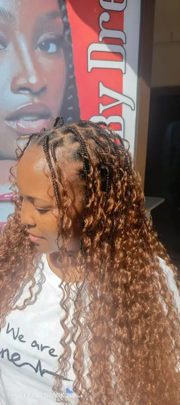 Long copper braids blended with loose flowing curls, supplied by NBD